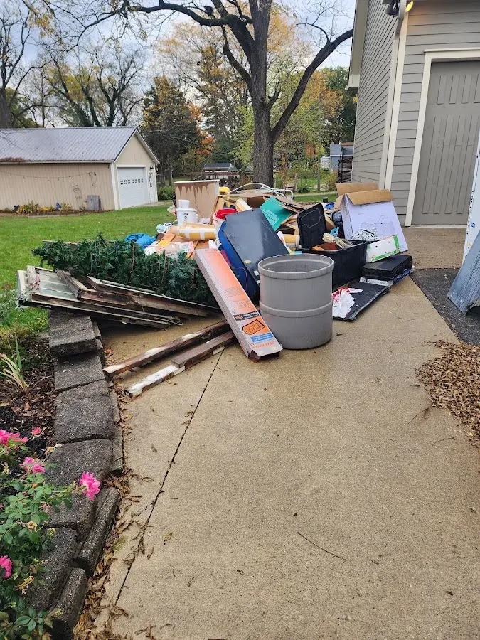 Dumpster being loaded with debris for Roofing Dumpster Rental in Winchester